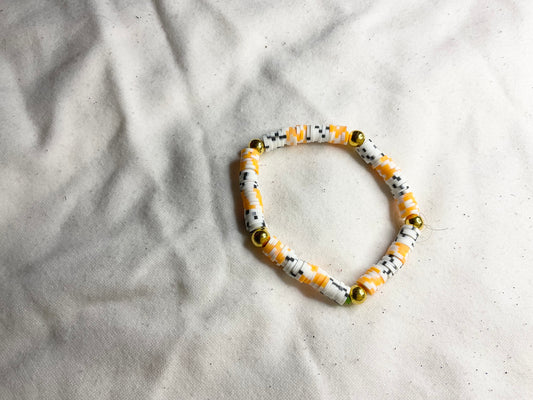 Black and Orange Checkered Clay Bead Bracelet with Gold Spacer Beads